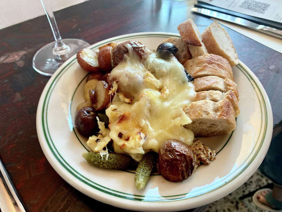 Raclette plate with roasted potatoes and pickles at Montrose Cheese & Wine
