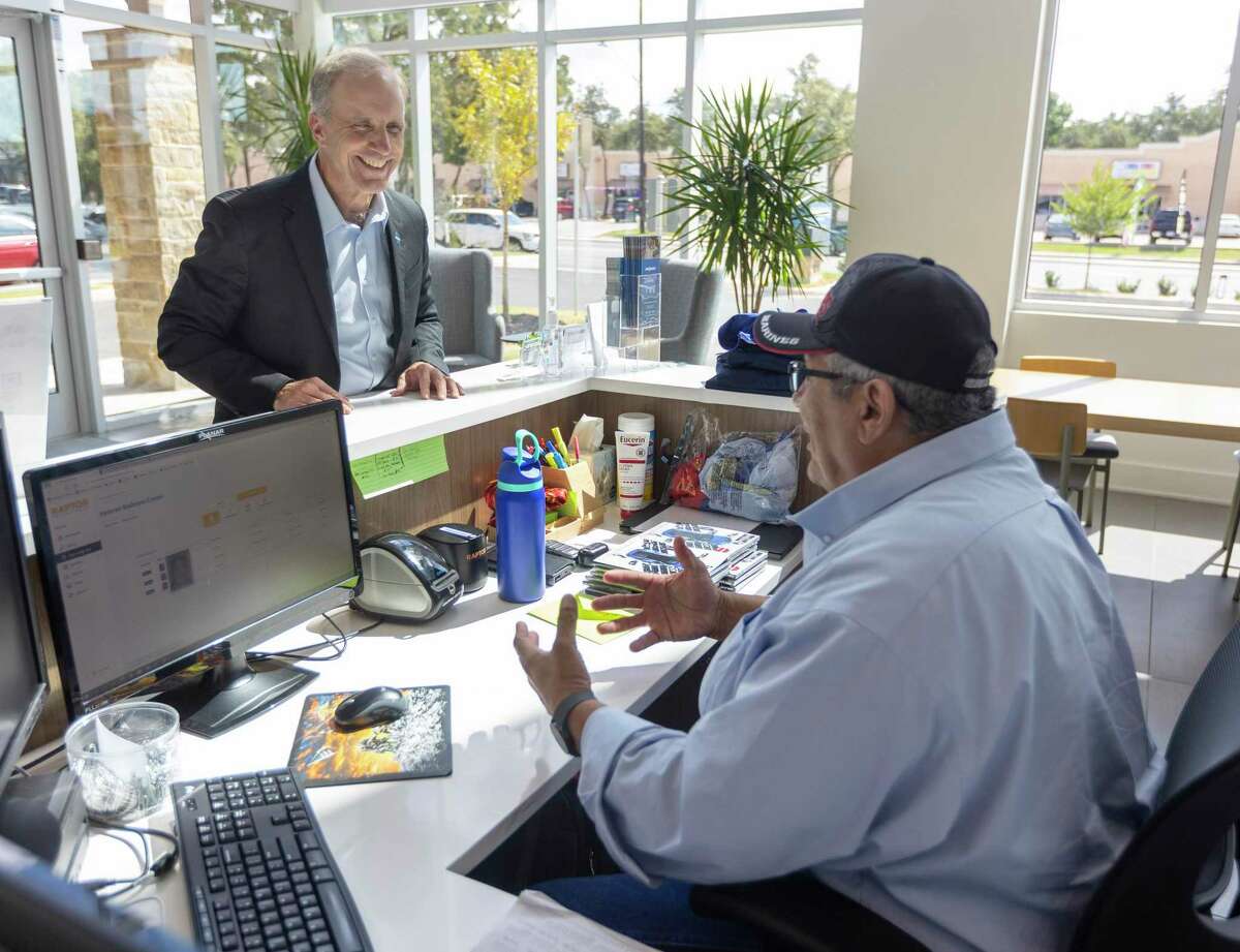 Chip Fulghum, left, head of Endeavors, chats with an employee at the multifaceted nonprofit, which provides charitable services through contracts with the federal, state and local governments.