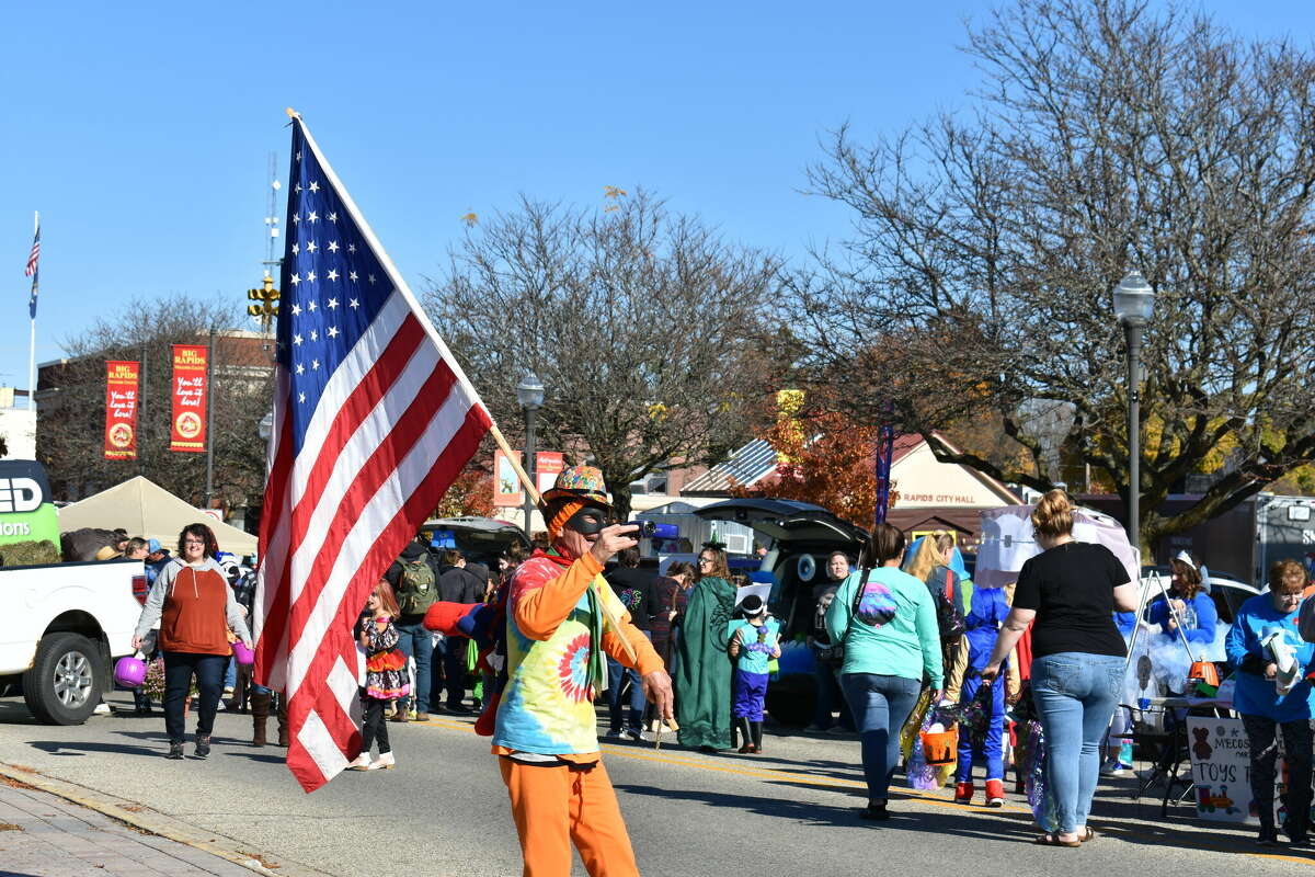 Timothy Seager (pictured) has spent hundreds of hours bringing joy to residents by donning creative outfits and waving an American flag in Big Rapids, Michigan and in Hardy, Arkansas. 