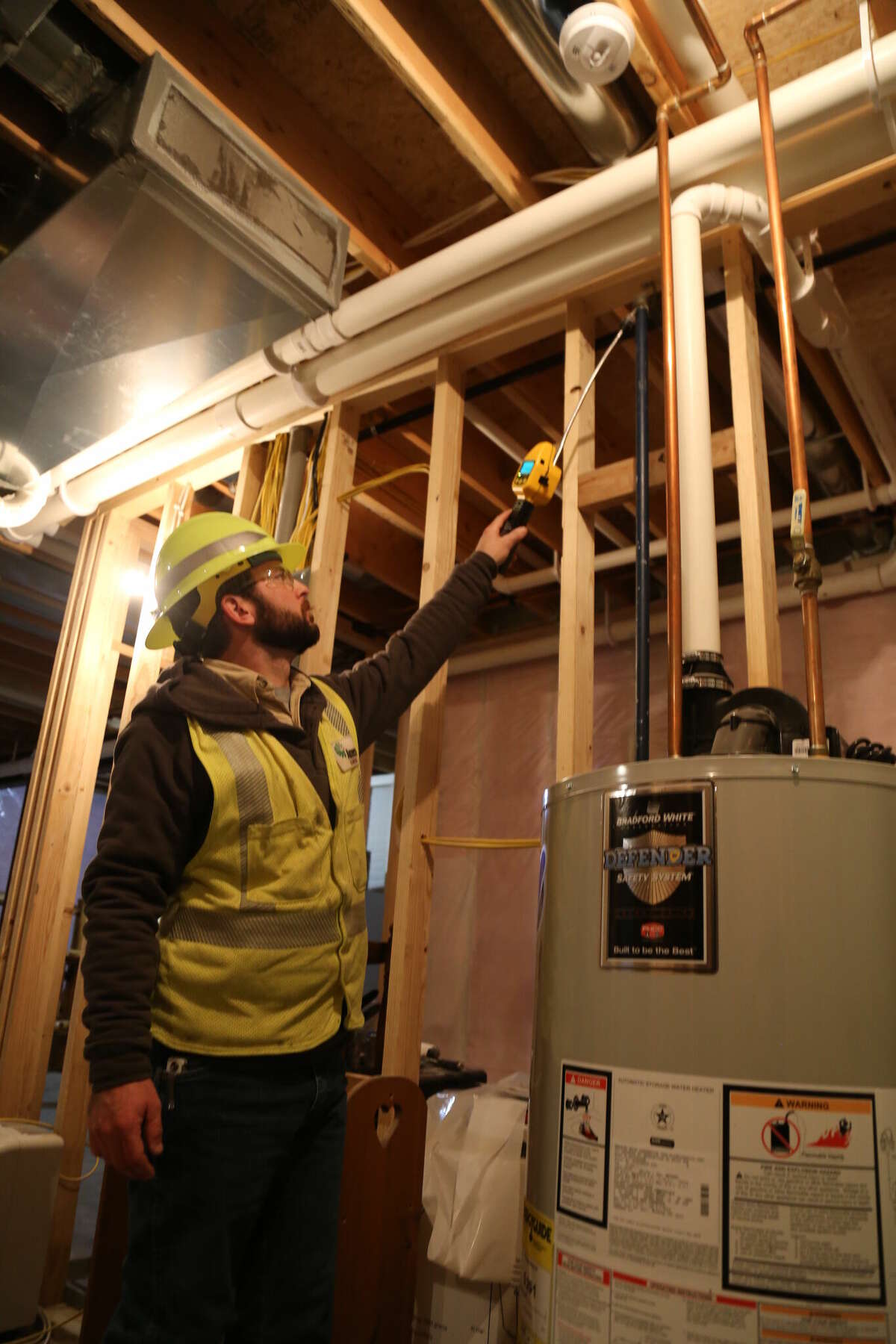 An Ameren Illinois natural gas journeyman inspects a customer's water heater for any gas leaks.