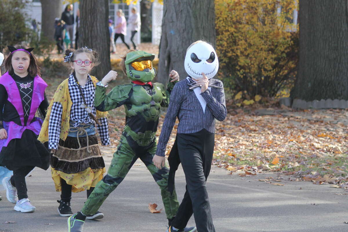 Jack Skellington and Master Chief lead a group of students down 28th Street Monday during Kennedy Elementary School's Halloween costume parade.