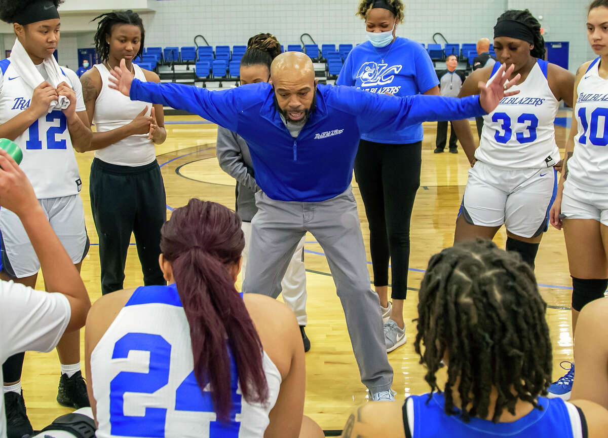 Lewis and Clark women's basketball coach Jaron Young gives instructions to his players during a timeout last season.
