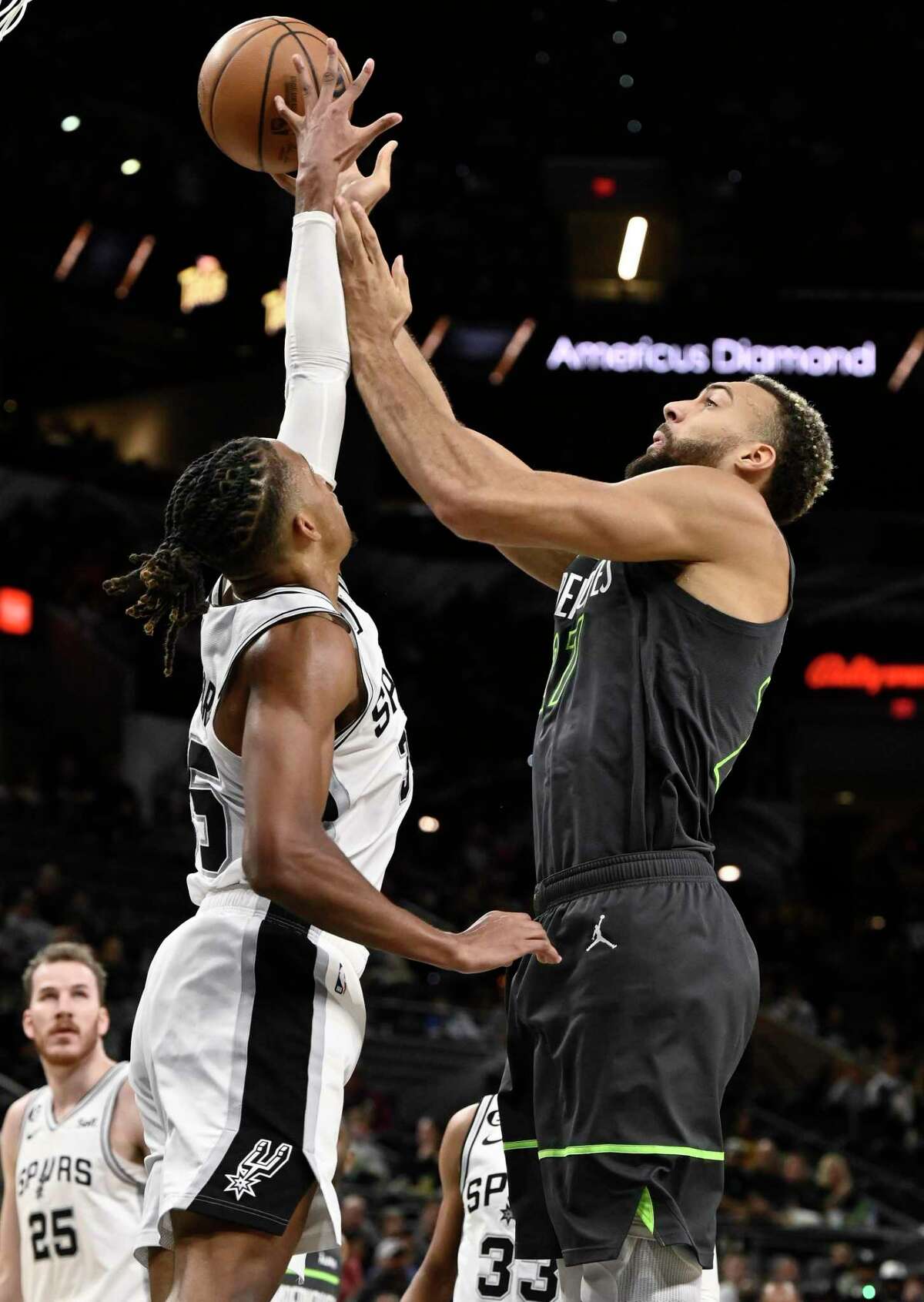 The Timberwolves' Rudy Gobert, right,knows something about good defense, and he experiences it firsthand courtesy of the Spurs' Romeo Langford.