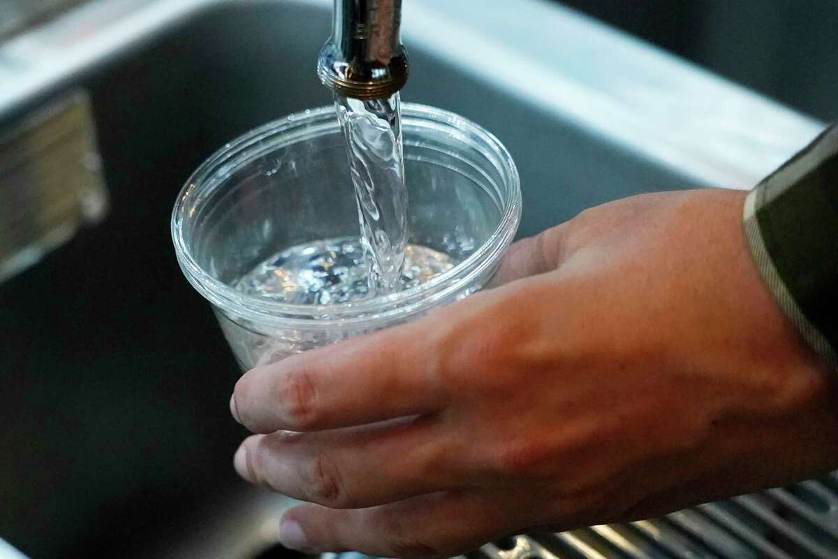 FILE - A cup of water is drawn from a faucet at Johnny T's Bistro and Blues, a midtown Jackson, Miss., restaurant and entertainment venue on Sept. 1, 2022. The beleaguered water system in Mississippi's capital city disrupted daily life for 150,000 residents for several days, but Jackson's water is now safe to drink according to the Environmental Protection Agency on Monday, Oct. 31, 2022.