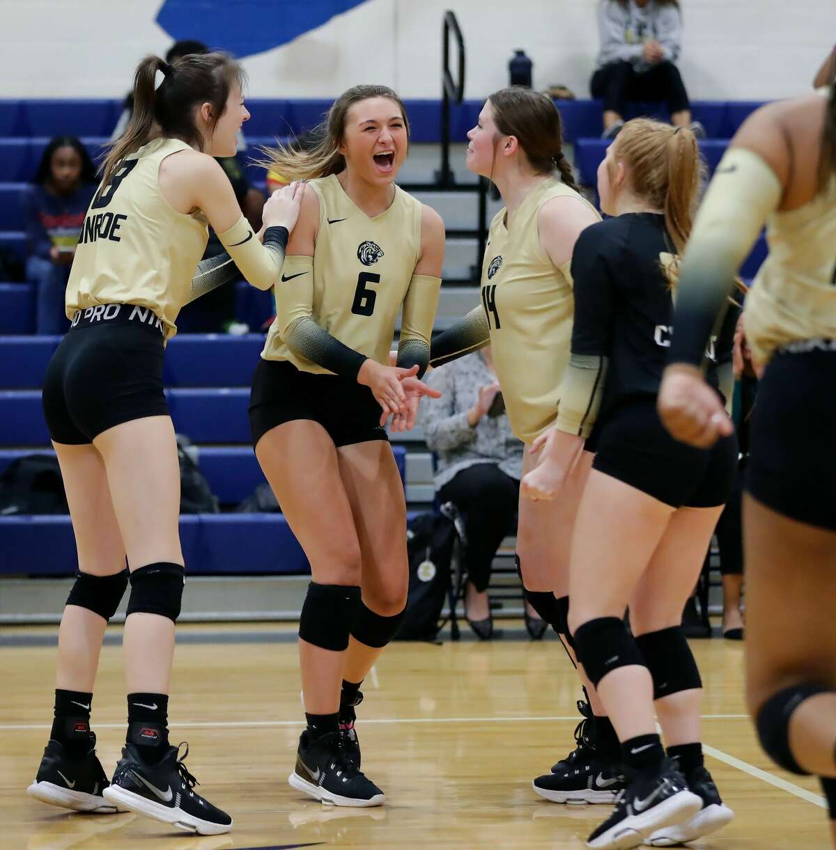 Conroe players celebrate after winning a point against Nimitz during their Region II-6A bi-district volleyball match at Nimitz High School Monday, Oct. 31, 2022 in Houston, TX.