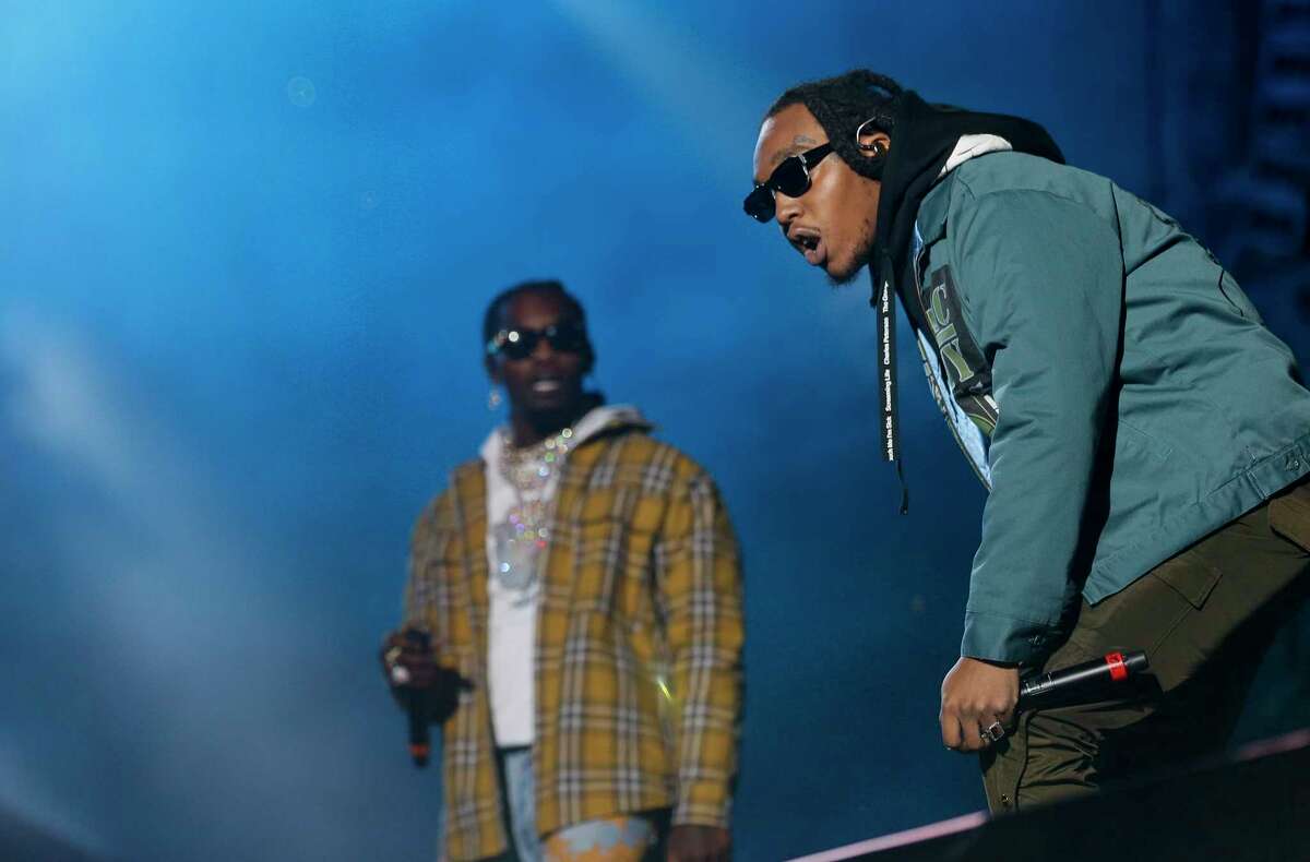 Takeoff, right, and Offset, background, with the Hip-Hop group Migos, performed at Travis Scott's AstroWorld Festival Saturday, Nov. 9, 2019, in Houston.