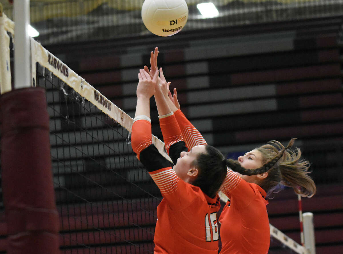 Edwardsville's Sydney Davis, left, and Addie Reader go up for a block against O'Fallon on Monday in the Class 4A Normal Community Sectional semifinals at Belleville West High School in Belleville.