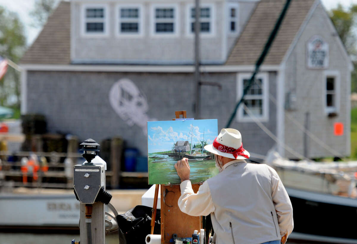 In this 2012 file photo, Frank Pollifrone Sr. of Naugatuck paints a landscape of the Guilford Lobster Pound building at the end of Whitfield Street in Guilford. 