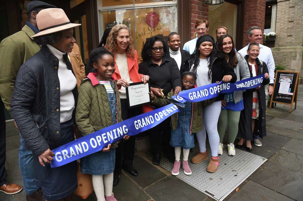 Soap-edi owner Francia Fortune, center, cuts a ribbon during a ceremony outside her new store on Chapel Street in New Haven November 1, 2022.