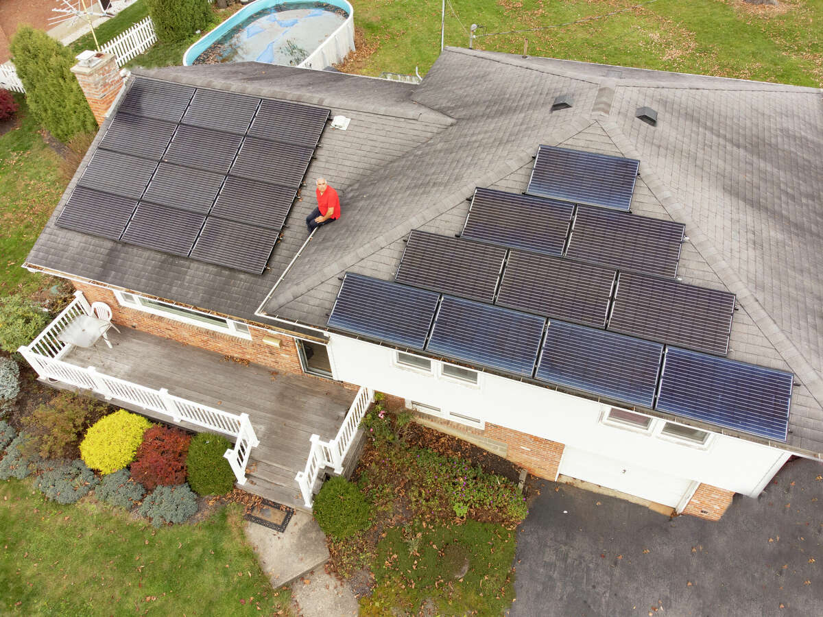 Gary McPherson shows off the solar panels on the roof of his Glenville house Tuesday, Nov. 1, 2022.