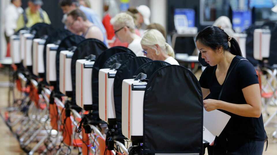 Voters cast ballots as early voting takes place in the polling location set up in the gym Monday, Oct. 24, 2022 at the Metropolitan Multi-Service Center in Houston, TX.