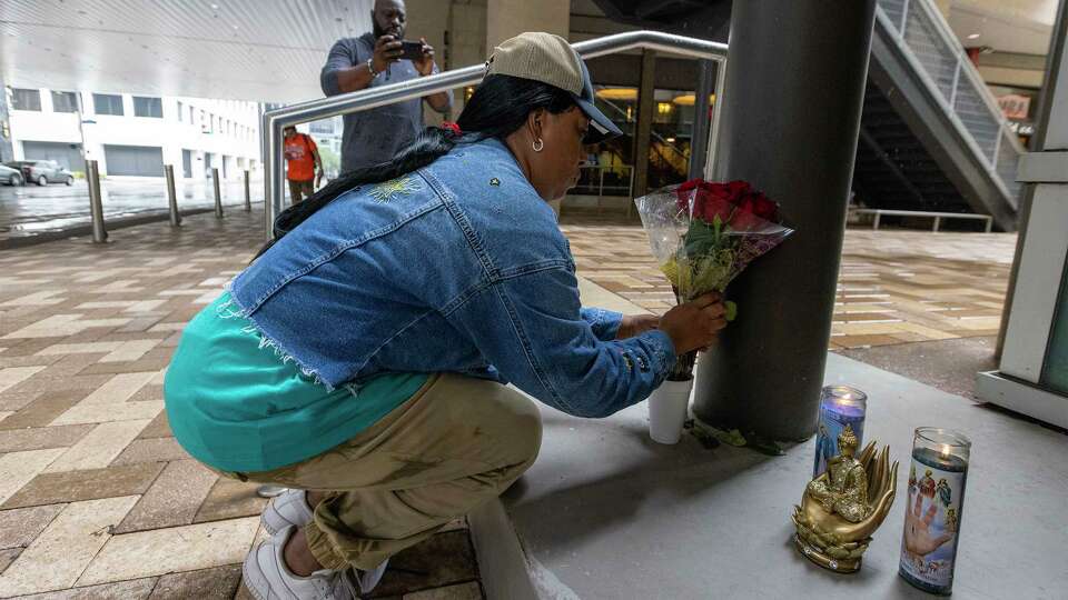 Marisa Brown lights a candle and prepares flowers for rapper Takeoff that was shot and killed at a private party at Houston bowling alley in Houston. Rapper Takeoff, a member of Atlanta-based rap group Migos, was fatally shot at a Houston bowling alley and pool hall early Tuesday, a group representative told the Associated Press. The 28-year-old was one of three people shot during a private event.