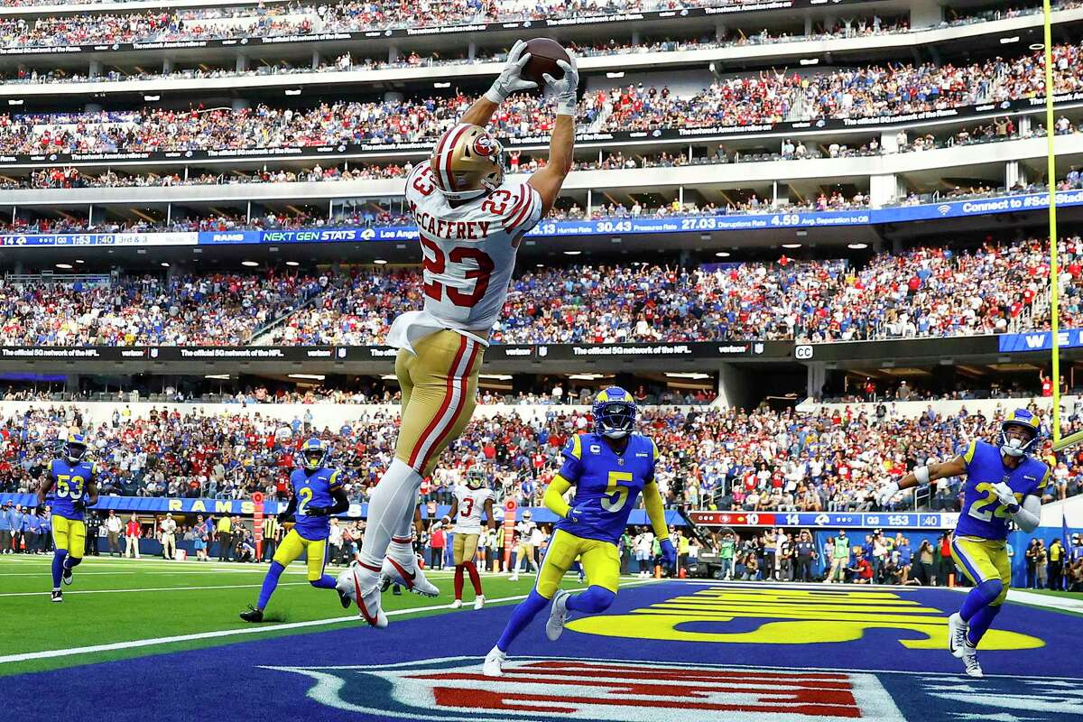 INGLEWOOD, CALIFORNIA - OCTOBER 30: Christian McCaffrey #23 of the San Francisco 49ers catches the ball for a touchdown as Jalen Ramsey #5 and Taylor Rapp #24 of the Los Angeles Rams defend during the third quarter at SoFi Stadium on October 30, 2022 in Inglewood, California. (Photo by Ronald Martinez/Getty Images)***BESTPIX***