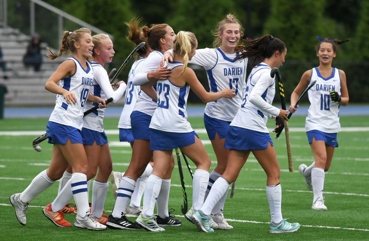 The Darien field hockey team celebrates a goal during its 4-1 win over Wilton in Darien on Tuesday, Oct. 4, 2022.