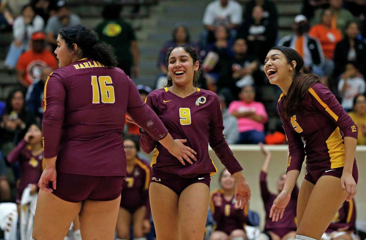 Harlandale Chanisty Villarreal-Bermea #9 celebrates a point with Cayla Reyes #16 and Jocelum Gutierrez #5 in a first-round volleyball playoff on Tuesday, Nov.1, 2022 at Alamo Convocation Center. Harlandale defeated Burbank 3-0.