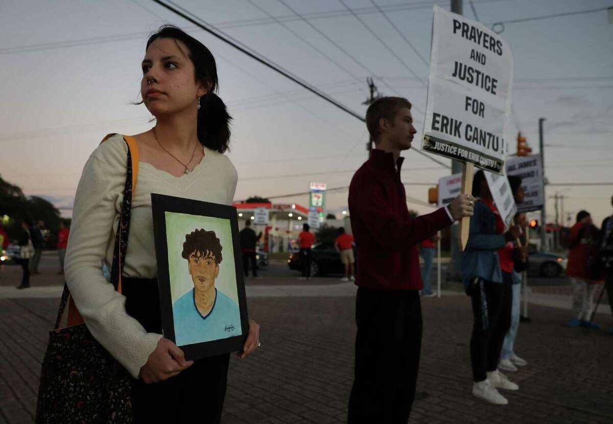 Alondra Lopez holds a portrait of Erik Cantu Tuesday evening as the group Party for Socialism and Liberation San Antonio gathers for a vigil and protest near Blanco Road and West Avenue near where Erik Cantu was shot on Oct. 2 by a San Antonio police officer. About 50 people held signs and candles to express their sorrow and outrage about the shooting of Cantu by former SAPD officer James Brennand. Cantu continues to recover in a hospital from bullet wounds.