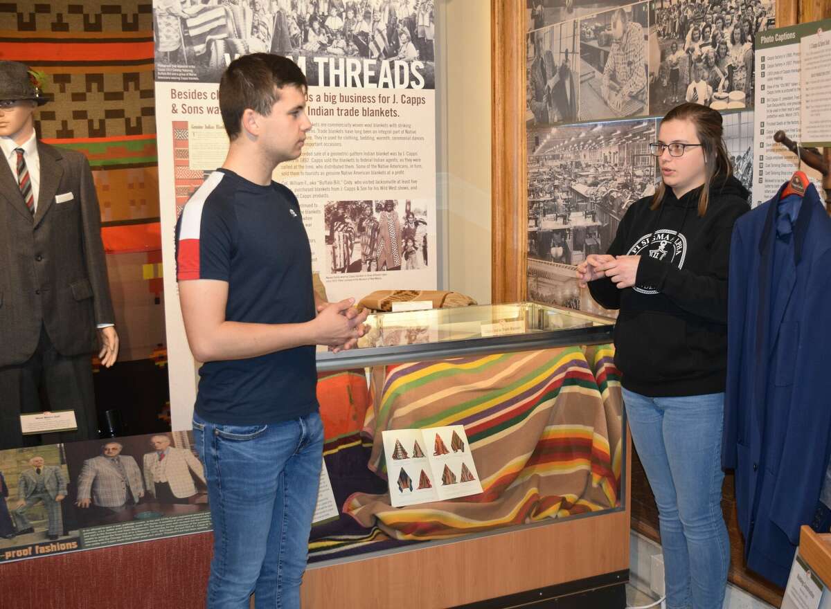Illinois College Pello Ruiz (left) and McKenna Servis, Jacksonville Area Museum manager and MacMurray Collections coordinator, discuss the J. Capps and Sons exhibit at the Jacksonville Area Museum. The museum is having a presentation on J. Capps & Sons and its connection to Buffalo Bill Cody. 