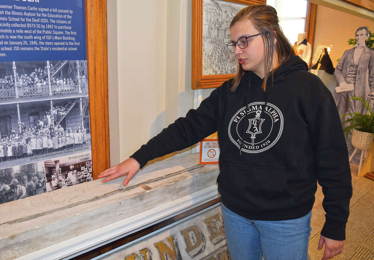 McKenna Servis, manager of Jacksonville Area Museum at 301 E. State St., looks at a windowsill from the former Jacksonville Developmental Center that contains carvings by its residents. The state-operated developmental center was open from 1851 until it was closed in November 2012. The museum features exhibits about notable Jacksonville residents and institutions.