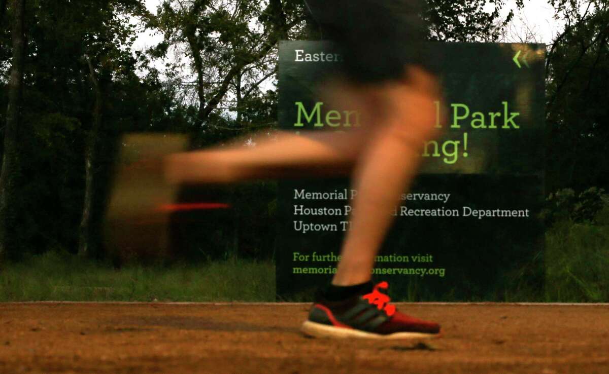 Runners run on the Eastern Glades trail at Memorial Park