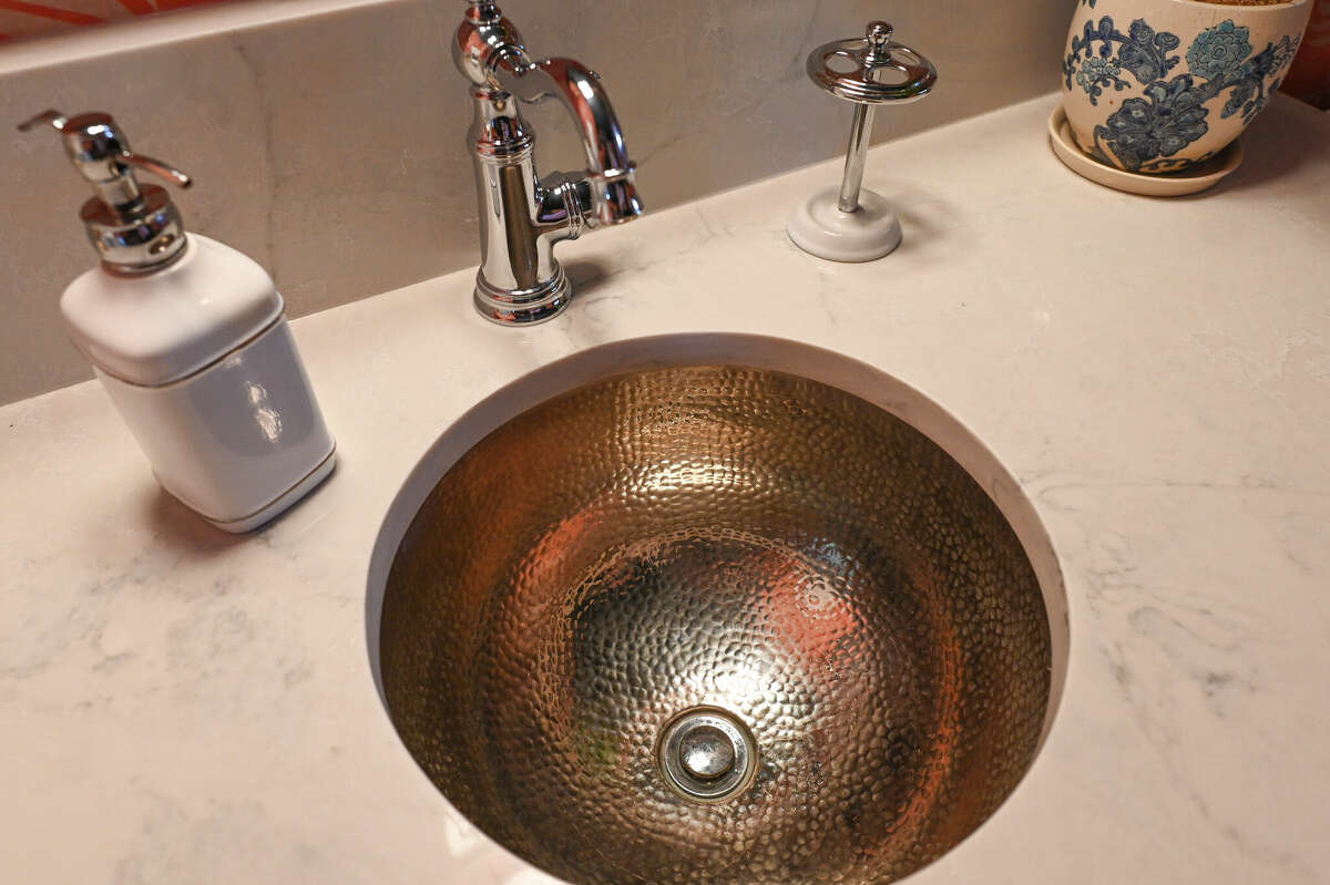 O’Brien made all the design and decorating decisions himself, including this hammered copper sink in one of the bathrooms.