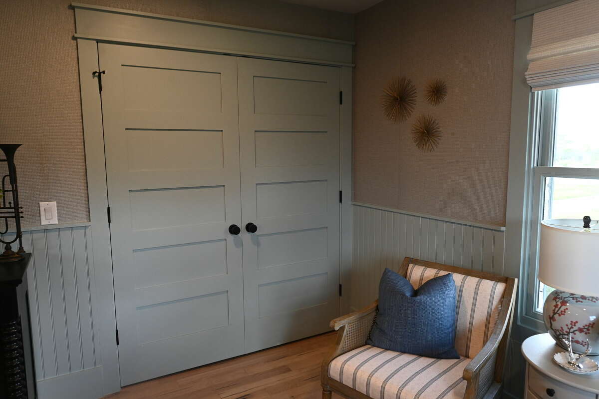 This guest room has large doors that open to an oversized closet.