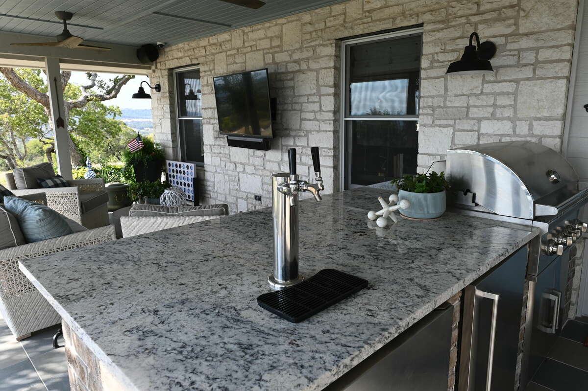 The back patio has a full kitchen that includes a beer refrigerator.