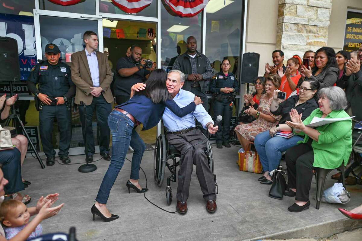Gov. Greg Abbott embraces Cassy Garcia, Republican candidate in the District 28 race against incumbent Democrat Henry Cuellar, at the RNC Hispanic Community Center in Laredo on Monday, Oct. 31, 2022.