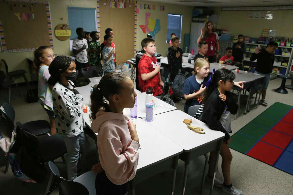 Students recite the Pledge of Allegiance in a portable classroom at East Central ISD’s Tradition Elementary School on Aug. 31, 2022. The school has more than 925 students and has to rely on portable buildings. Rapid subdivision growth pushed the district to call for a $240 million bond proposal, even after last year’s failure of a bond proposal.
