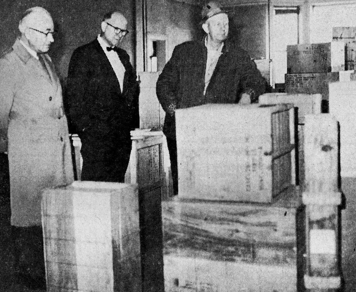 Inspecting the storage of equipment for the Civil Defense emergency hospital are county CD director, Jerome Manthei; city manager, Arthur Bergquist and fire Chief Herbert Olson. The equipment was moved  from the basement of Mercy Hospital to the third floor rooms of Manistee City Hall. The photo was published in the News Advocate on Nov. 6, 1962.