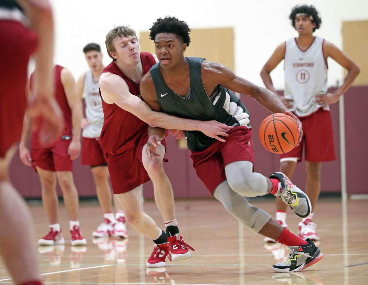 Stanford Men’s basketball’s Harrison Ingram drives against Michael Jones as Ryan Agarwal (11) watches during practice in Stanford, Calif., on Wednesday, November 2, 2022.