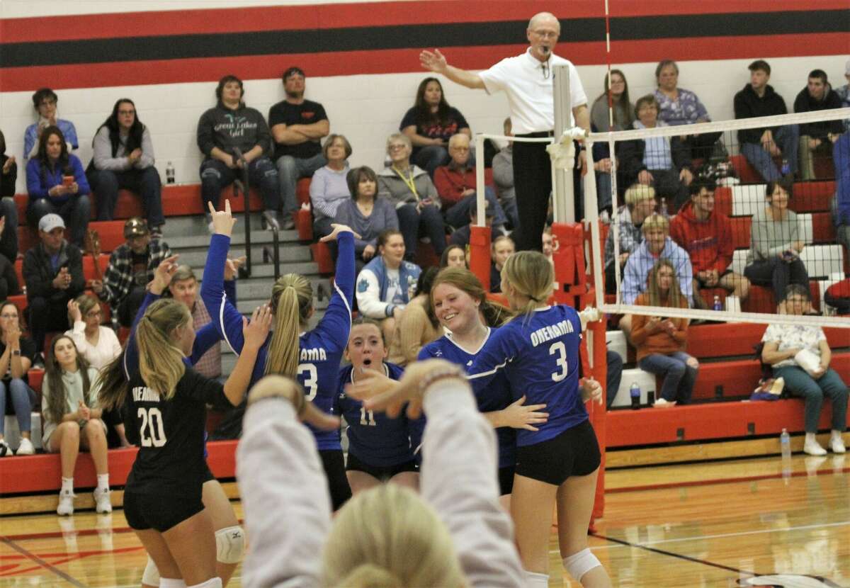 The Onekama volleyball team celebrates a point against Manistee Catholic Central on Nov. 2 at Bear Lake High School. 