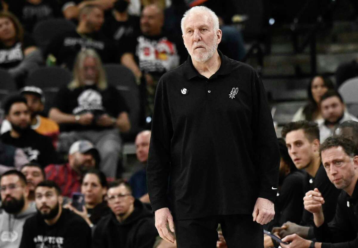 San Antonio Spurs coach Gregg Popovich watches during the first half of the team's NBA basketball game against the Toronto Raptors, Wednesday, Nov. 2, 2022, in San Antonio. The Raptors won 143-100. (AP Photo/Darren Abate)
