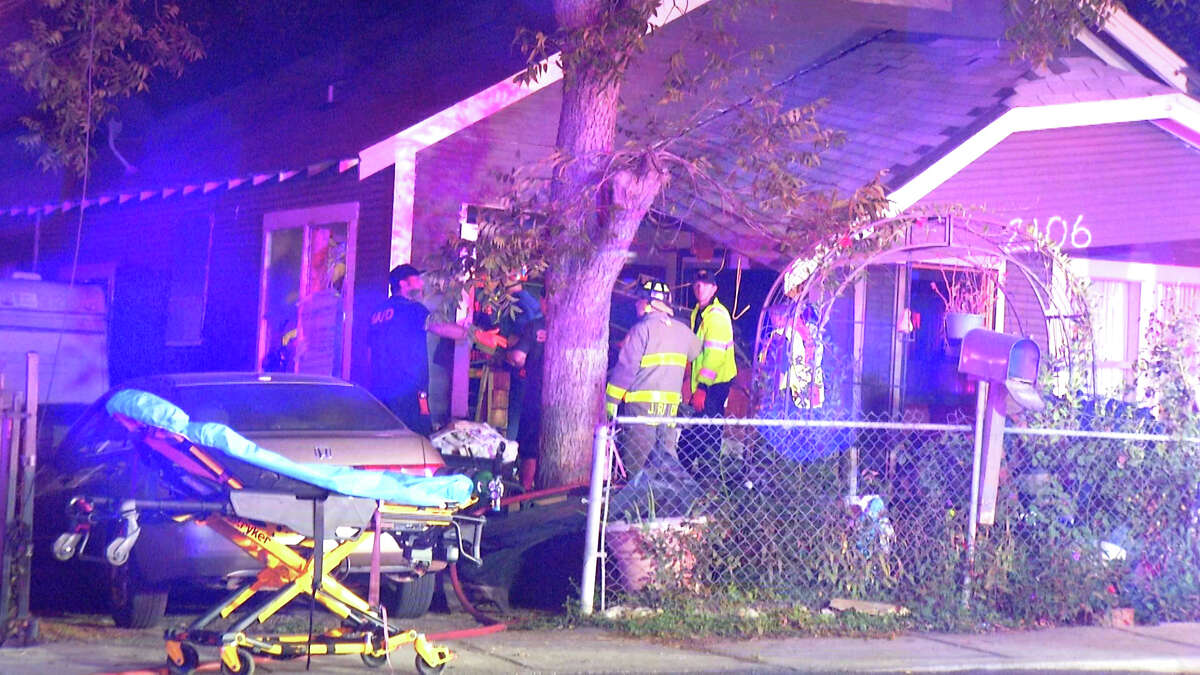 A 79-year-old woman was hospitalized after a vehicle drove into her house and pinned her under the car on the city's East Side on Thursday, November 3, according to the San Antonio Police Department.