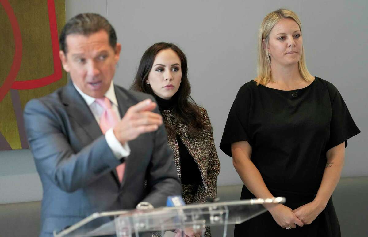 Attorney Tony Buzbee, left, attorney Crystal Del Toro, center, and client, Dr. Hillary Cauthen, a former San Antonio Spurs consulting psychologist, right, are shown during a press conference Thursday, Nov. 3, 2022, in Houston. Cauthen has accused former Spurs NBA player Josh Primo of exposing himself to her.