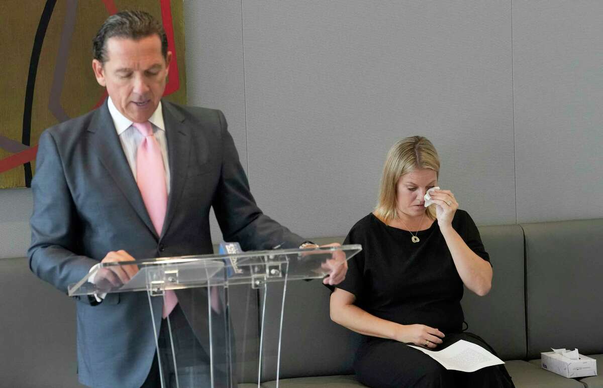 Tony Buzbee speaks during a press conference as former San Antonio Spurs consulting psychologist Dr. Hillary Cauthen wipes away tears Thursday, Nov. 3, 2022, in Houston. Cauthen has accused former Spurs NBA player Josh Primo of exposing himself to her.
