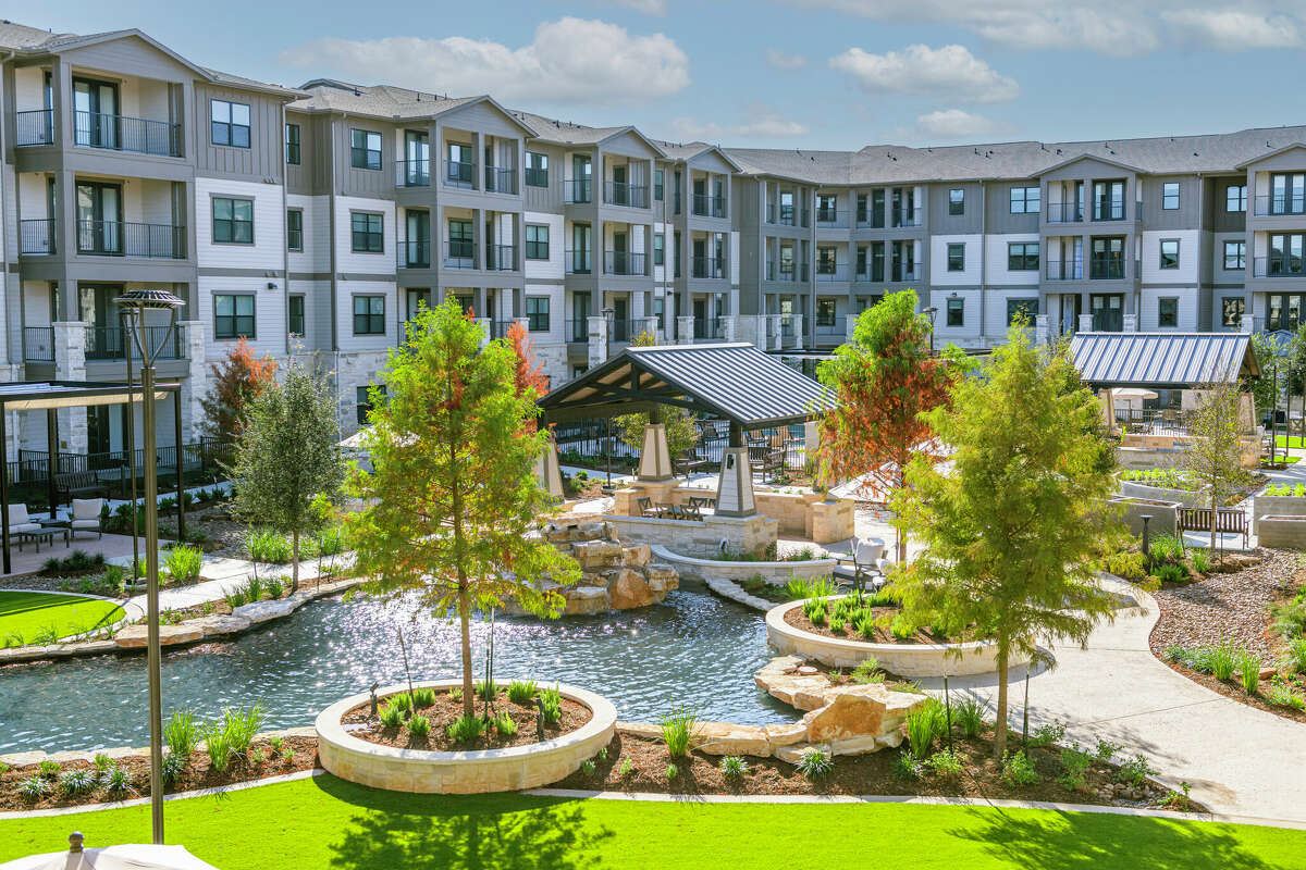 Walking trails surround a waterfall at Cadence Creek at Gosling, an active adult apartment development of Caldwell Communities at 21901 Gosling Road in Spring.