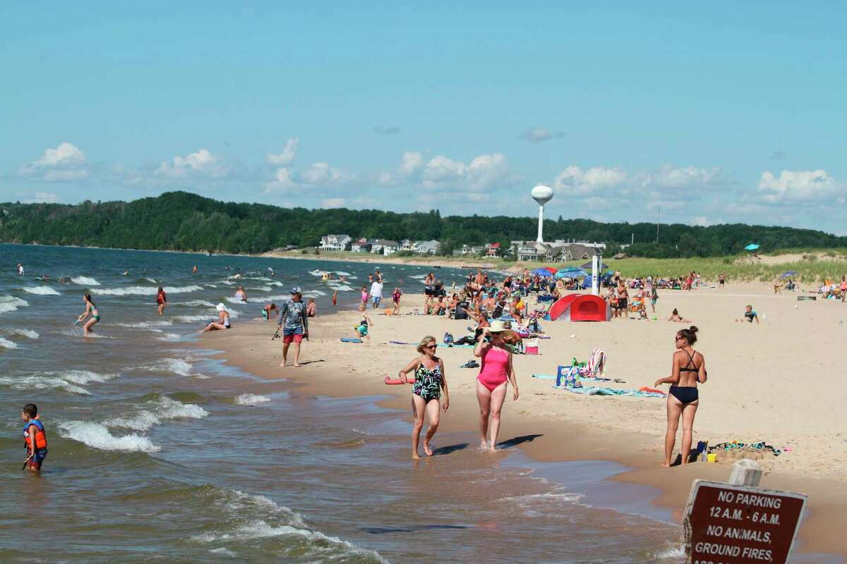Crowds gather at First Street Beach in Manistee in this 2021 photograph. A recent study found the population of Manistee County increases dramatically during summer months with overnight visitors, seasonal workers and short-term rentals. 