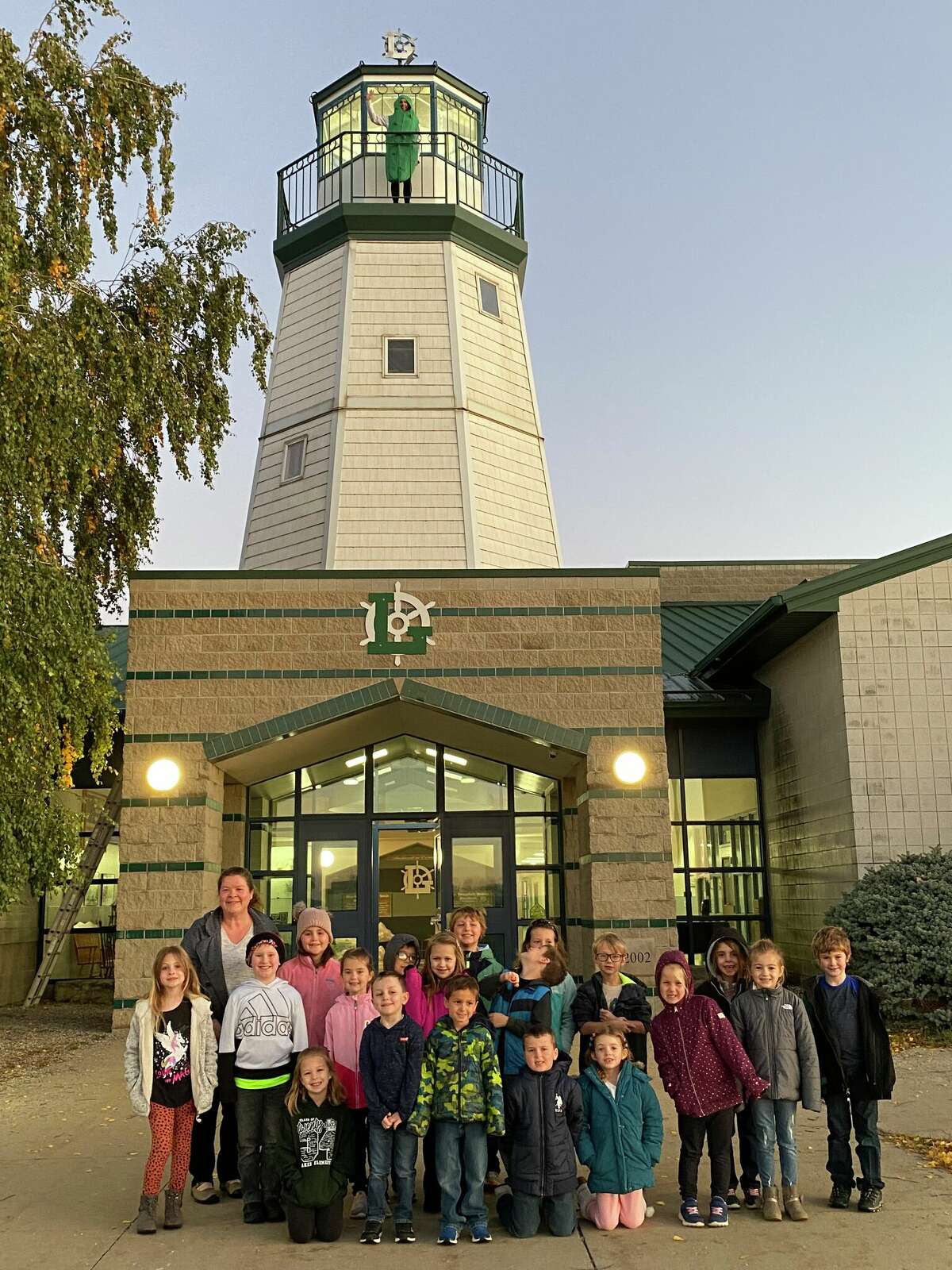 VerBurg scales the lighthouse as students reach the 2,000 pairs donation total.