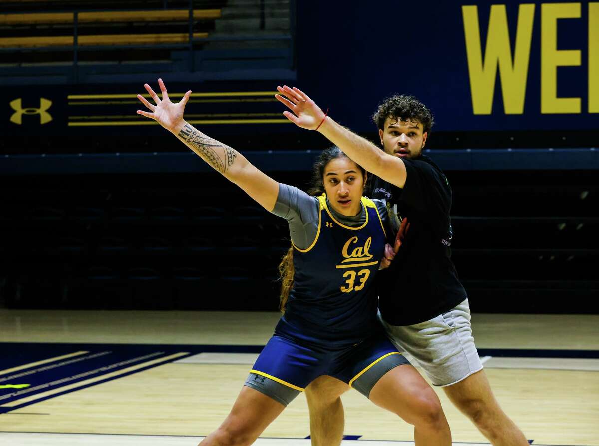 Forward Peanut Tuitele (33) is guarded by Devin Lewis, a male practice player, during the women?•s basketball practice at Haas Pavilion at the University of California, Berkeley on Wednesday, October 26, 2022, in Berkeley, Calif.