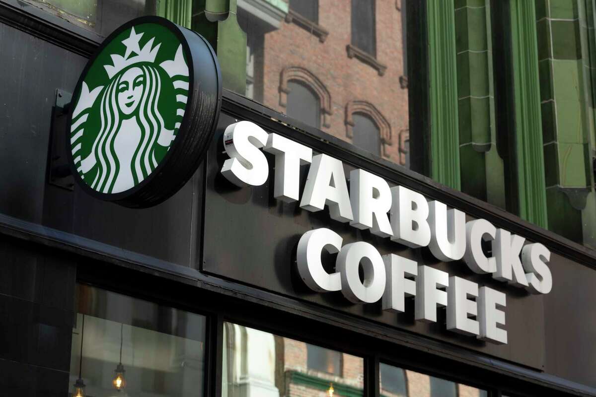 FILE - The Starbucks logo is seen on a storefront, Friday, Oct. 14, 2022, in Boston Starbucks reports quarterly financial results Thursday, Nov. 3, 2022.