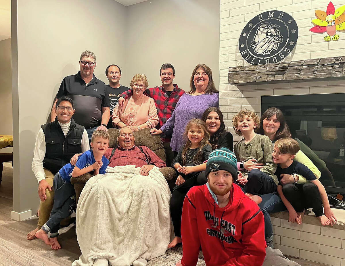 Manilan Houle, far left in a white shirt with black vest, pictured with his foster care family in November 2021 during a Thanksgiving gathering in Duluth, Minnesota.