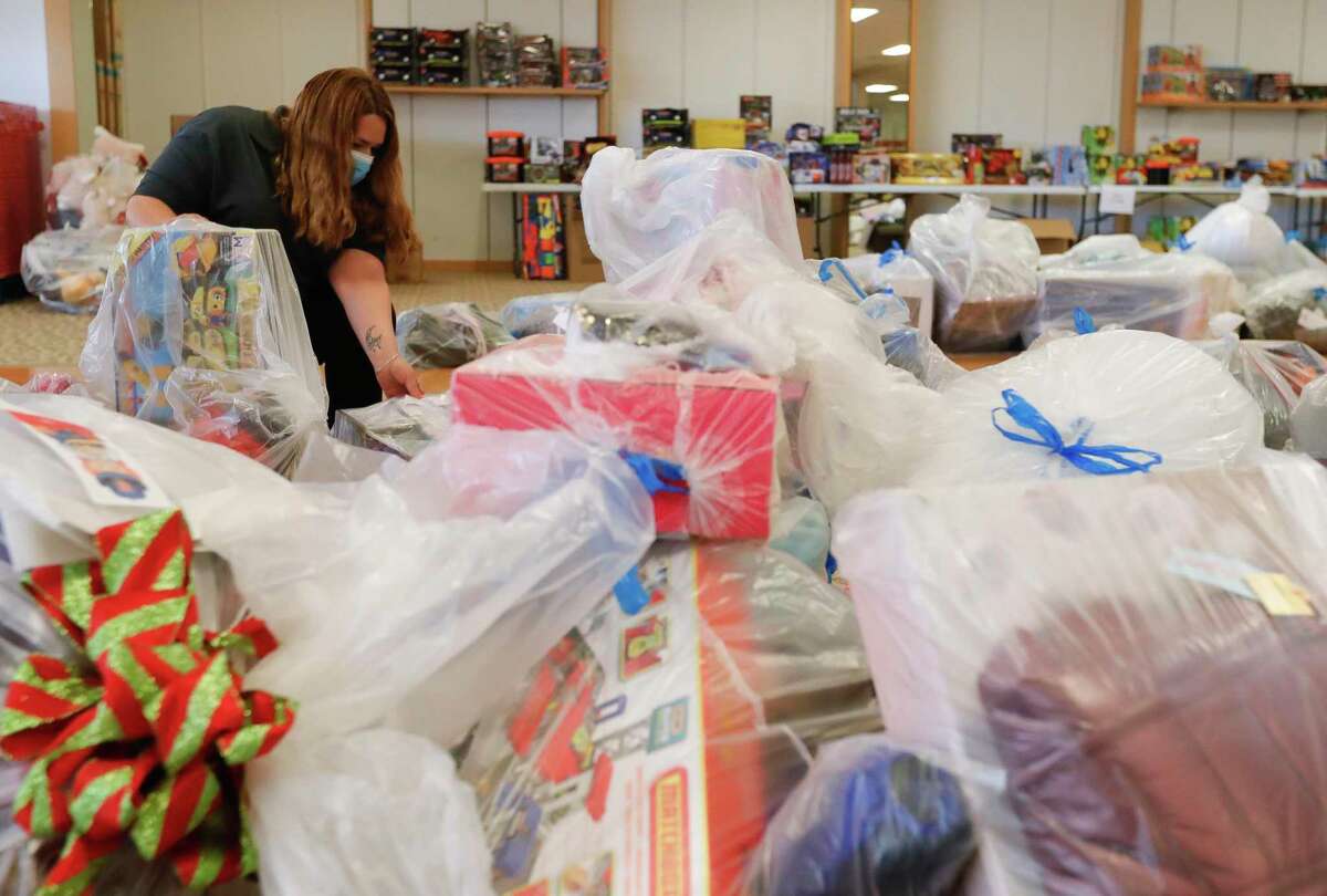 Dolores Tull helps sort through bags of toys for Salvation Army's annual angel tree gift assistance program at the Conroe Outlet Mall, Thursday, Dec. 3, 2020, in Conroe.