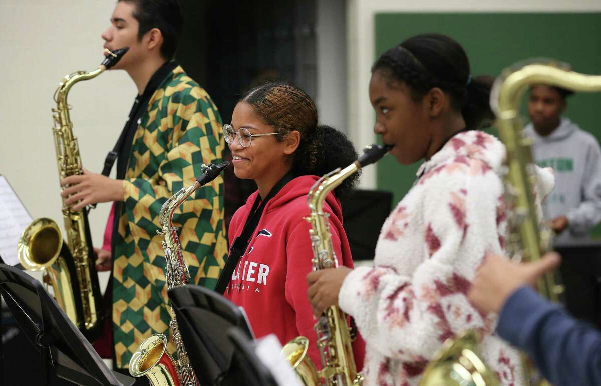 Sam Houston High School saxophonists, including senior Naveah Miller (center), enjoy a workshop with jazz vibraphonist Stefon Harris, who performs at the Carver Community Cultural Center on Friday.
