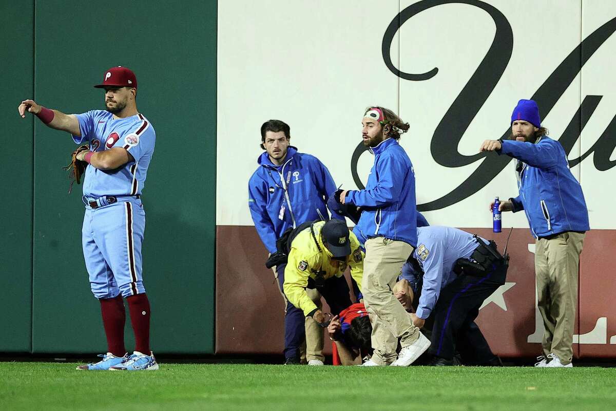 PHILADELPHIA, PENNSYLVANIA - NOVEMBER 03: A fan is removed from the field by security during the sixth inning between the Houston Astros and Philadelphia Phillies in Game Five of the 2022 World Series at Citizens Bank Park on November 03, 2022 in Philadelphia, Pennsylvania.