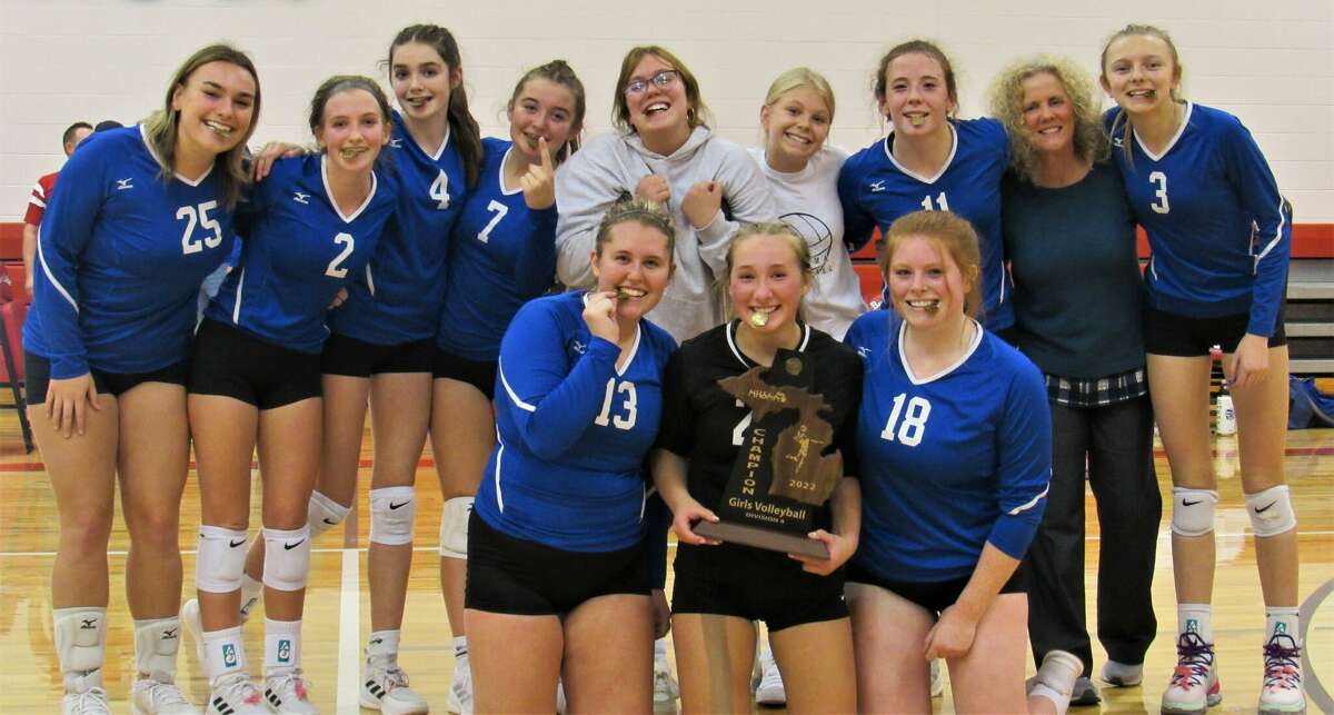 The Onekama volleyball team poses with its district championship trophy on Nov. 3 at Bear Lake High School. 