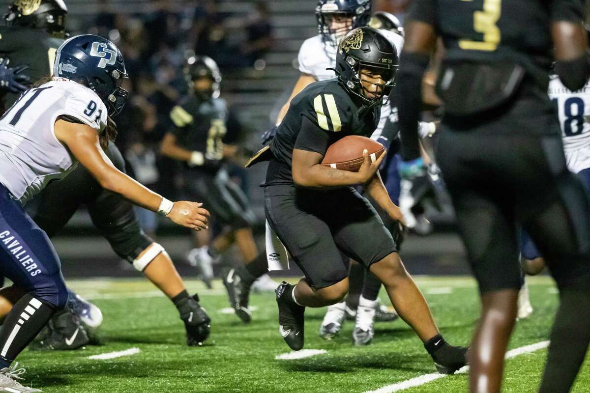 Conroe quarterback Javarious Hatchett (11) carries the ball on a QB keeper for a touchdown in a high school football game between College Park and Conroe Thursday, Nov 3, 2022, in Conroe.