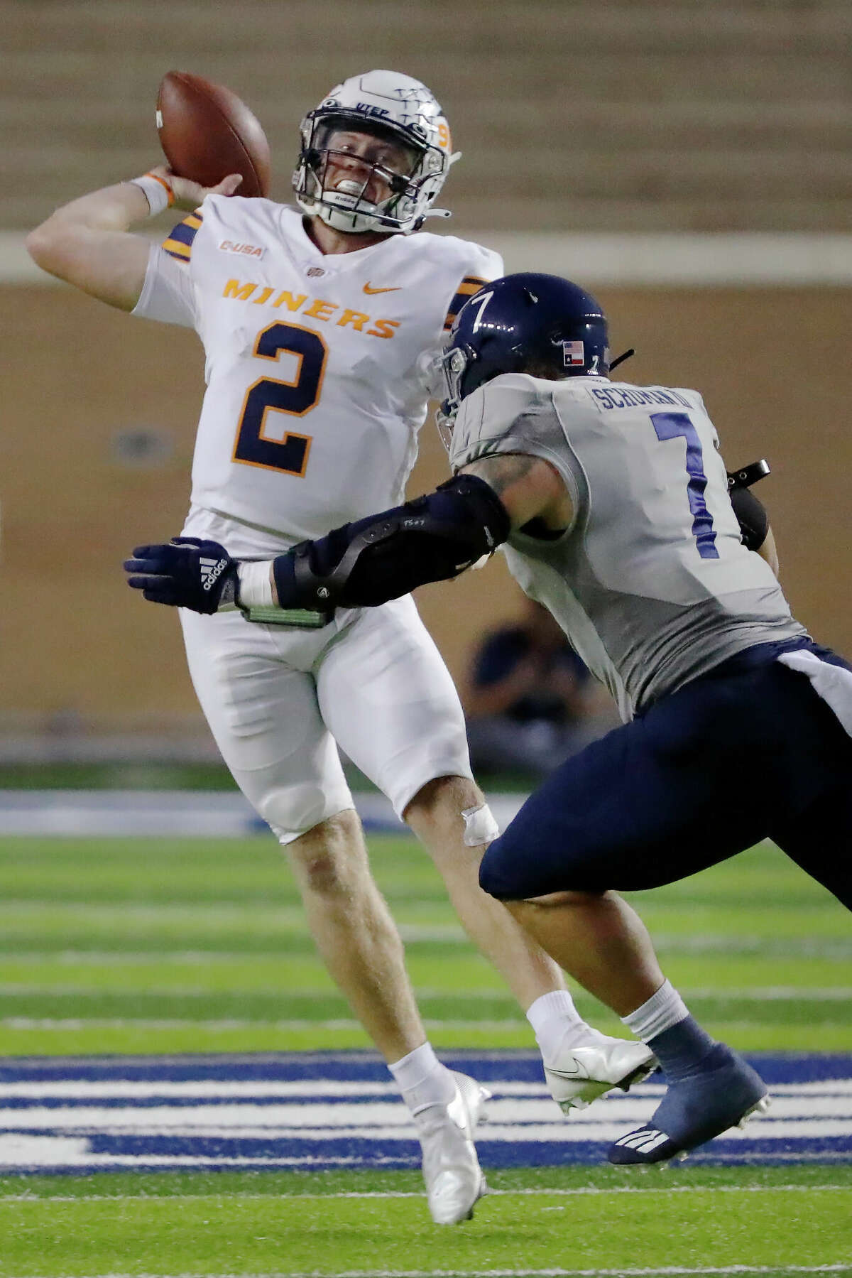 UTEP quarterback Gavin Hardison (2) passes the ball while under pressure from Rice defensive end Trey Schuman (7) during the first half of an NCAA college football game Thursday, Nov. 3, 2022, in Houston. (AP Photo/Michael Wyke)