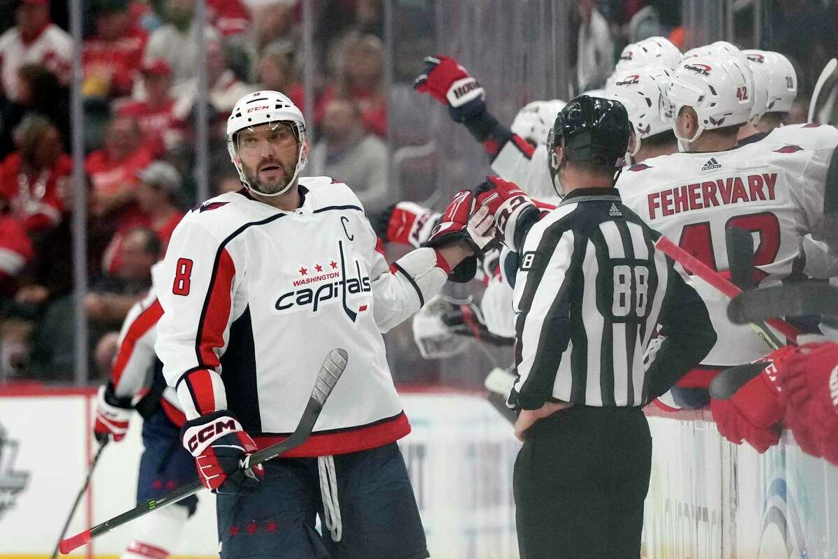 Washington Capitals left wing Alex Ovechkin greets teammates after scoring during the second period of an NHL hockey game against the Detroit Red Wings, Thursday, Nov. 3, 2022, in Detroit. (AP Photo/Carlos Osorio)