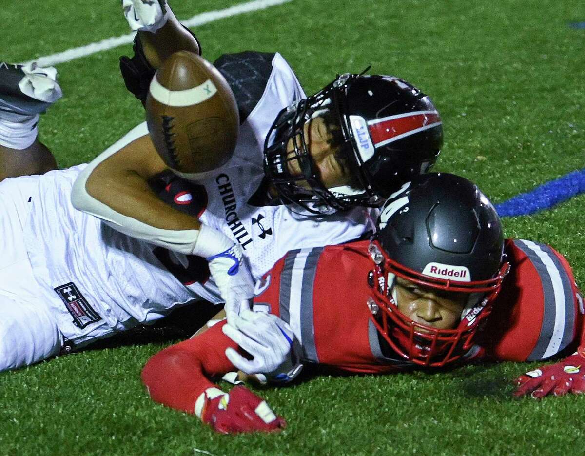 Churchill recover Diego Marsh, in white, and LEE defender Jayden Bryant, bottom, collide on a pass attempt that fell incomplete during high school football action at Comalander Stadium on Thursday, Nov. 3, 2022.