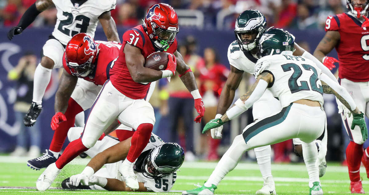 Houston Texans running back Dameon Pierce (31) avoids a tackle by Philadelphia Eagles defensive tackle Marlon Tuipulotu (95) during the third quarter of an NFL game between the Houston Texans and Philadelphia Eagles at NRG Stadium in Houston on Thursday, Nov. 3, 2022.
